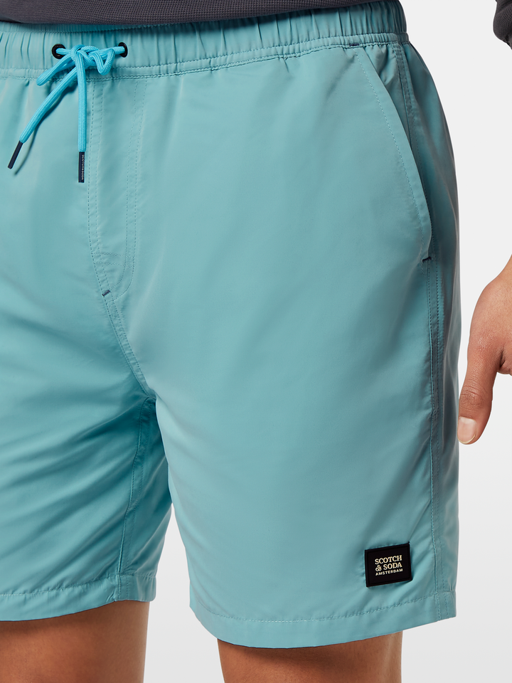 Solid mid-length swim shorts